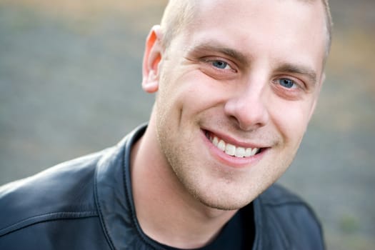 Closeup of the face of a happy young man with a big smile.