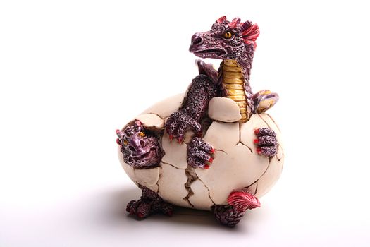 Ceramic figure of dragons hatching from egg.