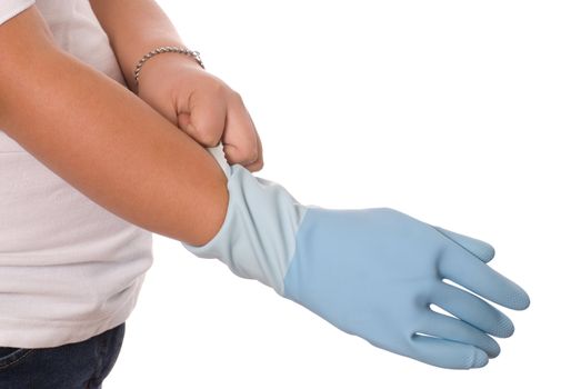 A girl putting on some tight cleaning gloves, isolated against a white background