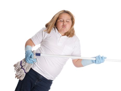 A young girl pretending to play the guitar on a mop, isolated against a white background