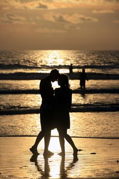 Couple on sunset. Coast of the Indian ocean