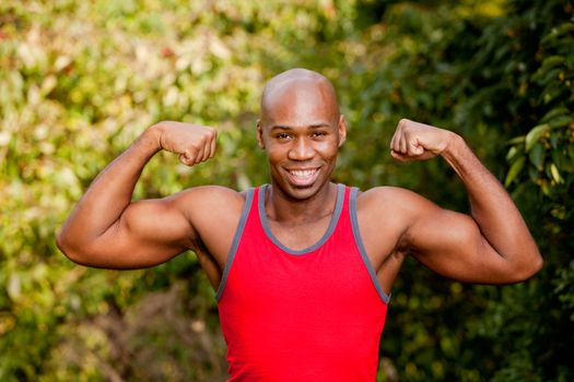 An African American man flexing his Bicep