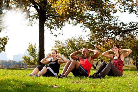 A group of people doing exercises in the park