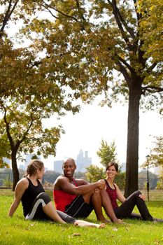 A group of people relaxing in the park after exercise