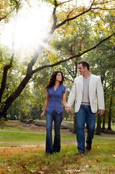 A happy couple walking in the park - looking at each other