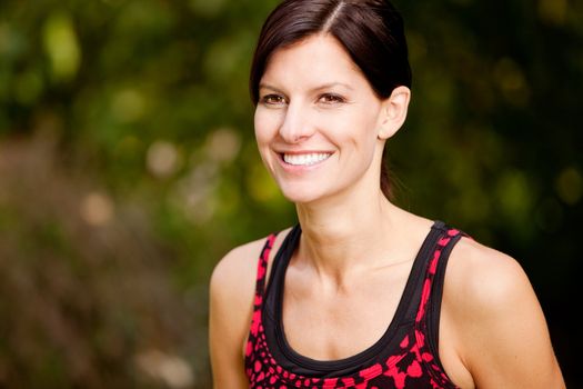 A happy fitness woman in the park - lifestyle portrait