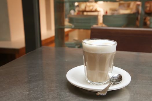 Cafe Latte Coffee on a Saucer with Teaspoon