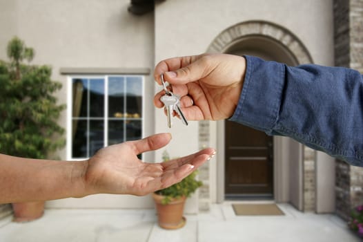 Handing Over the House Keys in Front of a Beautiful New Home.