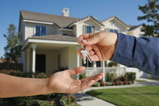 Handing Over the House Keys in Front of a Beautiful New Home.