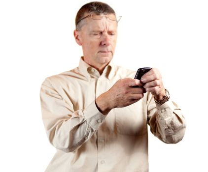 Senior businessman looking at blackberry type phone with spectacles on forehead
