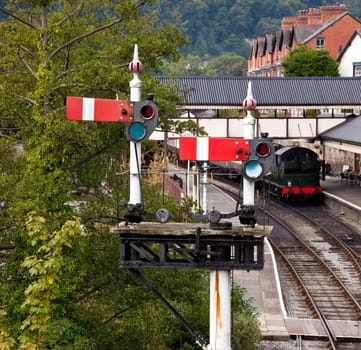 View of the station platform in Llangollen in Wales framed by signals