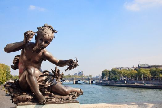 View of the Seine from Pont Alexandre III framed by small impish statue
