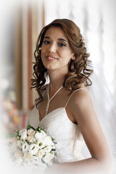 The beautiful bride with a wedding bouquet