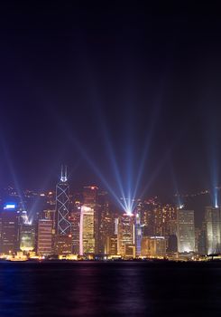 Famous night scenes of rays show on Victoria Harbor in Hong Kong.