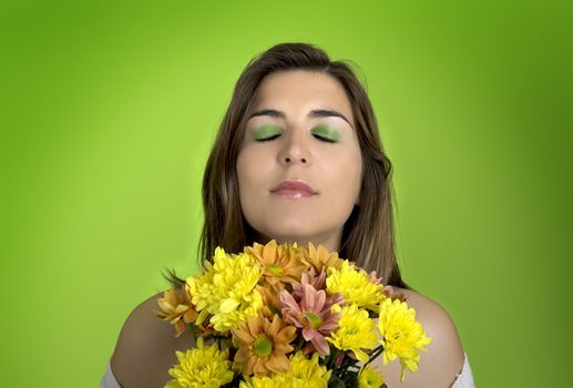 Beautiful woman with flowers on a green background