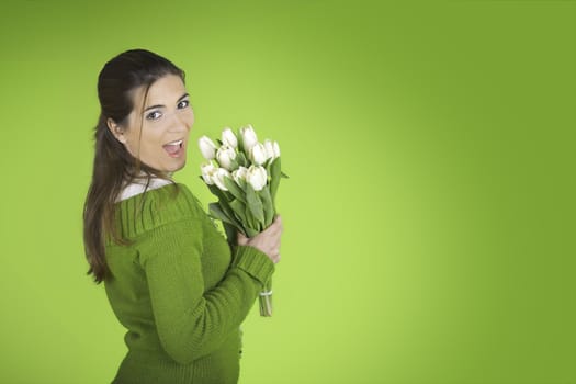 Beautiful woman with tulips on a green background