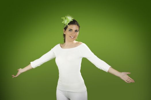 Beautiful easter woman with open arms on a green background