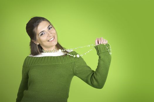 Happy beautiful model holding is necklace 