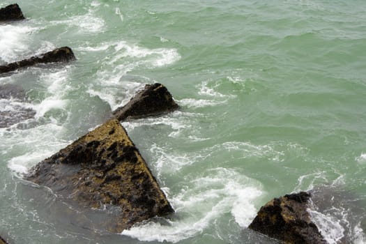 image of some rocks in the sea in a pier