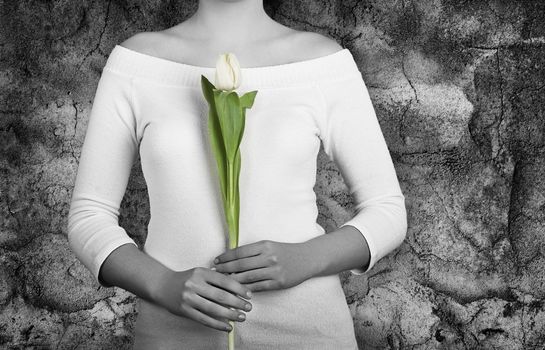 Woman with white tulips on is hands (Partial desaturated picture)