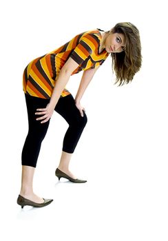 Beautiful young woman posing on white background with hands on the knees