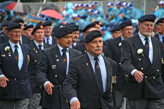 Veterans marching in the rain on Veterans Day
