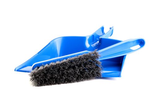 Dust-pan and brush of dark blue colour with a black bristle for dust cleaning on a white background.
