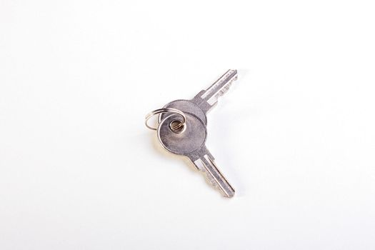 Two keys on a ring for a door-lock on a white background.