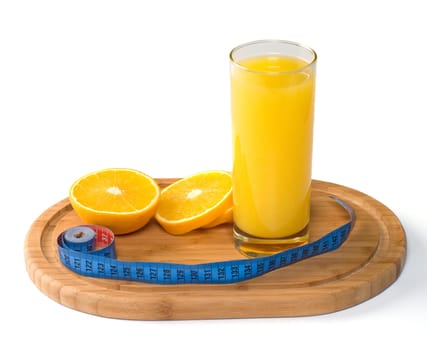 The juice glass, the cut orange and tape-line on a chopping board.