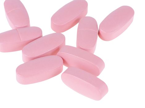 The pink tablets isolated on white background