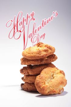 Five sweet cookies are combined one on another and the fifth is located before them. Happy Valentine's Day