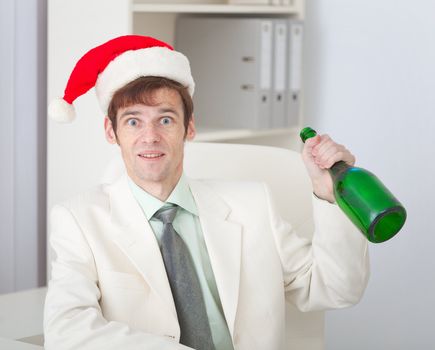 The businessman cheerfully celebrates Christmas at office