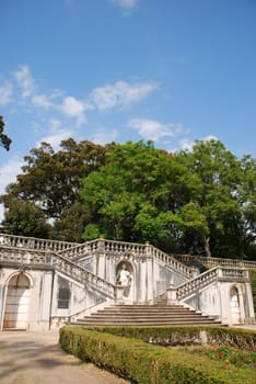 beautiful ornamental Ajuda garden with an antique staircase and statue in Lisbon, Portugal