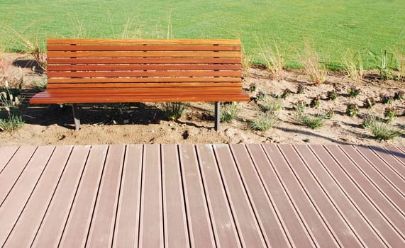 photo of a an empty park bench in a green park 

