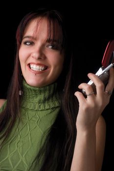 Twenty something fashion model holding cell phone with big smile