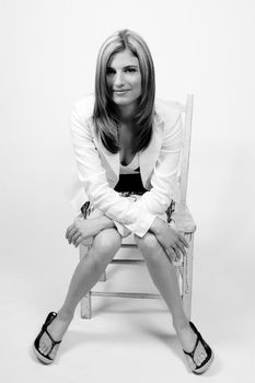 women in casual business attire sitting on a green chair