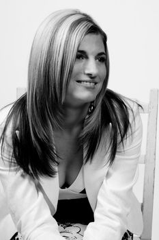 women in casual business attire sitting on a green chair