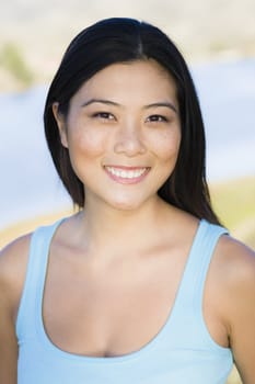 Portrait of a Smiling Young Asian Woman Looking To Camera