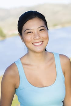 Portrait of a Smiling Young Asian Woman Looking To Camera