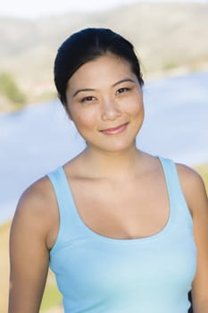 Portrait of a Young Asian Woman Outdoors Looking To Camera