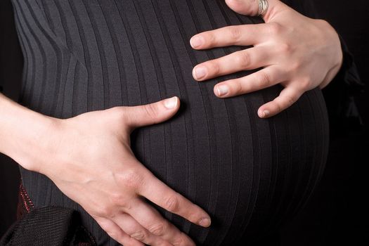 Close up of a pregnant belly being hold