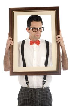 A young, caucasian nerd, holding up a frame, isolated on a white background.