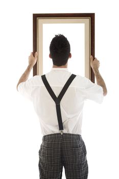 A young, caucasian nerd, holding up a frame, isolated on a white background.