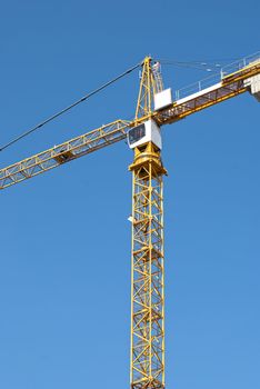 Yellow crane on blue sky background