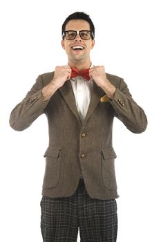 A young, caucasian nerd ajusting his bow-tie, isolated on a white background.