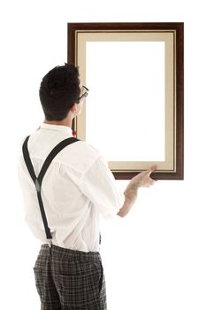 A young, caucasian nerd, holding up a frame, isolated on a white background.