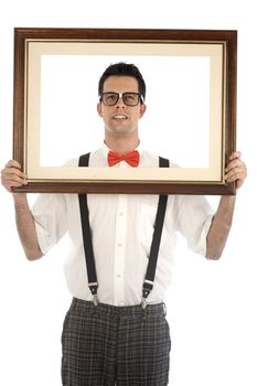 A young, caucasian nerd, holding up a frame, isolated on a white background.