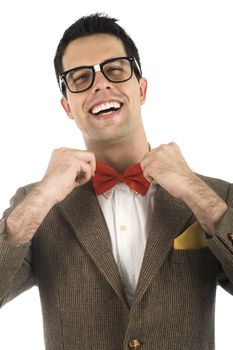 A young, caucasian nerd ajusting his bow-tie, isolated on a white background.