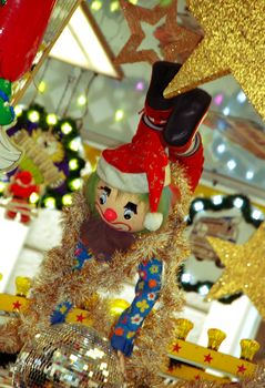 Clown on Christmas market, colorful shining background