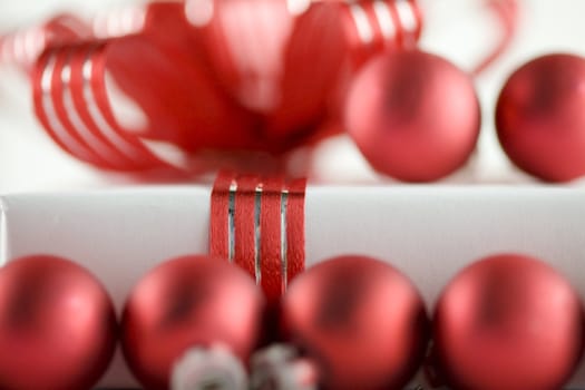 White present with red ribbons on a dinner plate, christmas theme